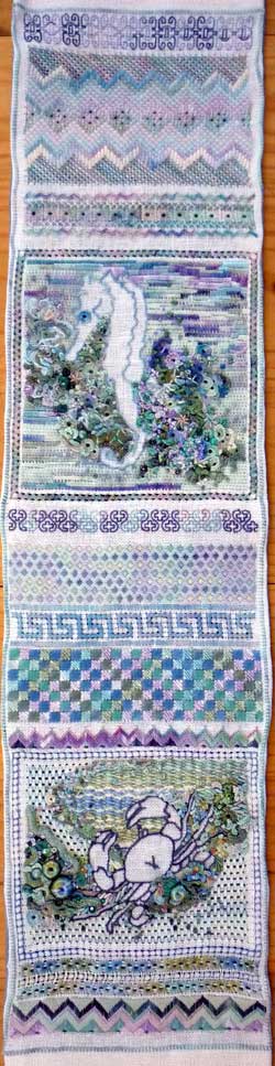 hand embroidered area of a needlework sampler 