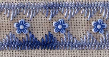 hand embroidered area of a needlework sampler