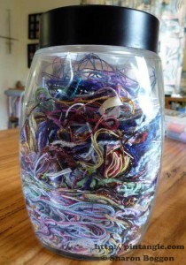 full jar of threads that will become fabric from scrap threads 