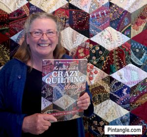 holding my book in front of quilt