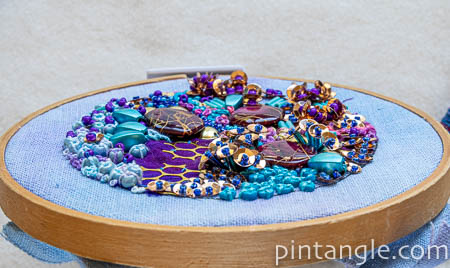side angle view of contemporary hand embroidery including beads, sequins 
