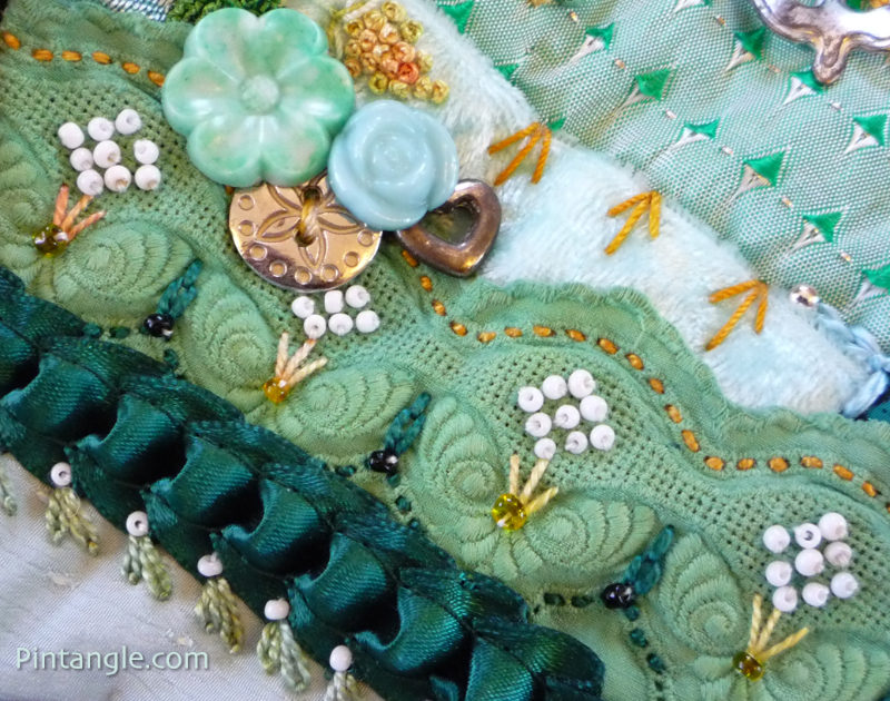 Embroidered lace and buttons demonstrating the idea for embellishing crazy quilt blocks