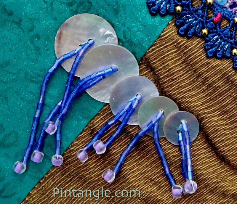 Button tassels demonstrating the idea for embellishing crazy quilt block