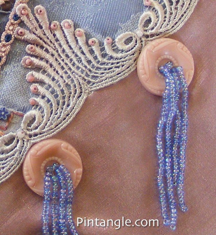 Button tassels demonstrating the idea for embellishing crazy quilt block